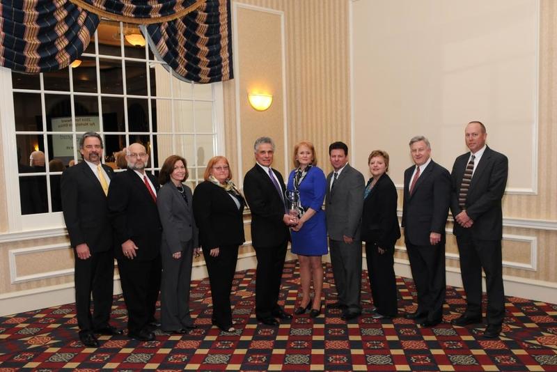 Accepting the Torch Award for Marketplace Ethics presented to Tidewater Utilities by the Better Business Bureau of Delaware are (l-r) Alan Jones, Ken Cross, Christine Mondock, Sheila Shannon, Jerry Esposito, Carol Murphy, Ray Ebaugh, Bernadette Sohler, Dennis Doll and Bruce Patrick. SOURCE SUBMITTED